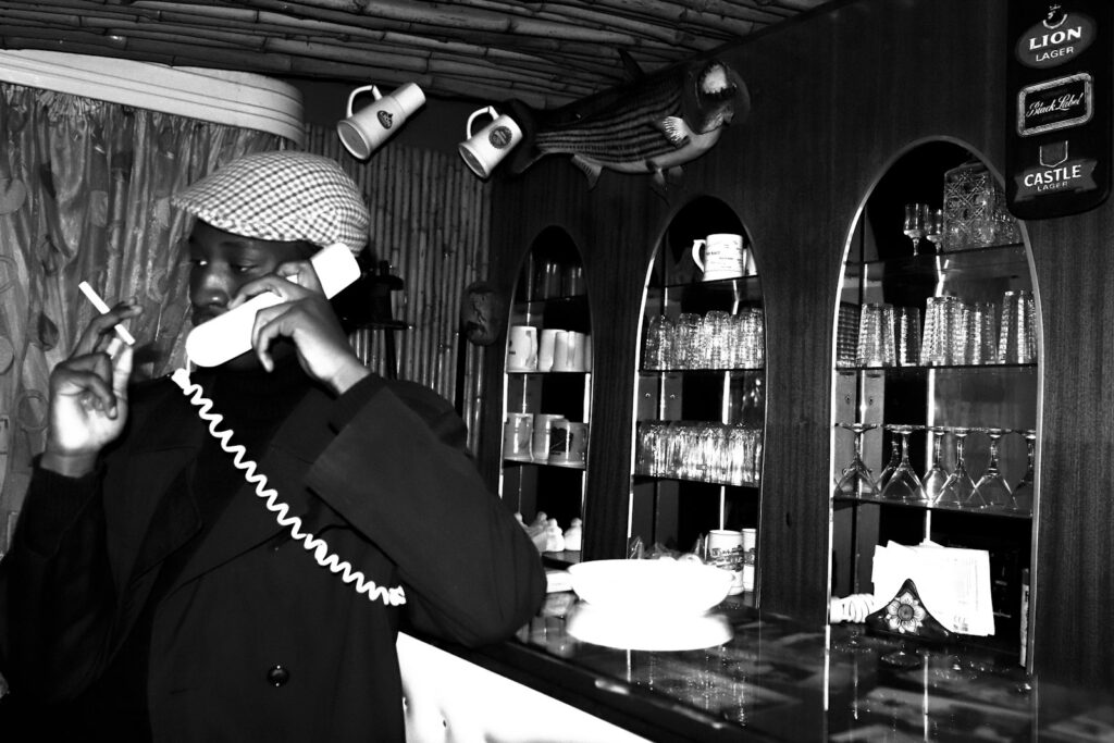 Restaurant host on the phone, a job an AI receptionist for small business can help with