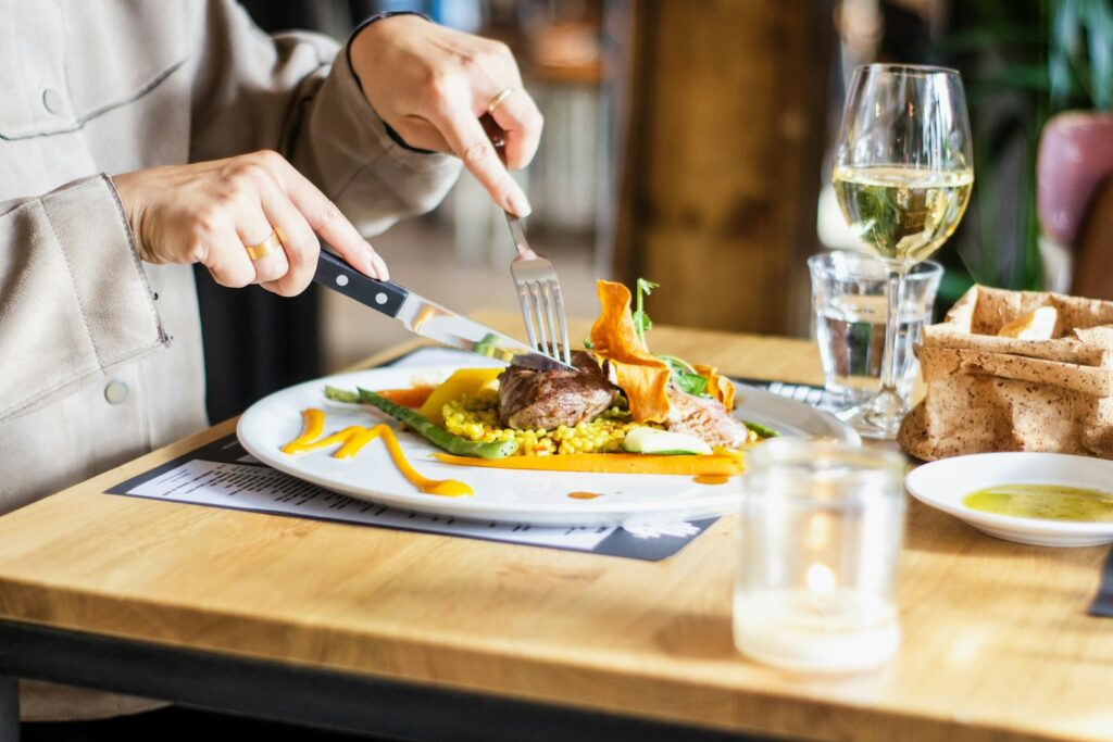 Diners sharing plates of food at a restaurant table