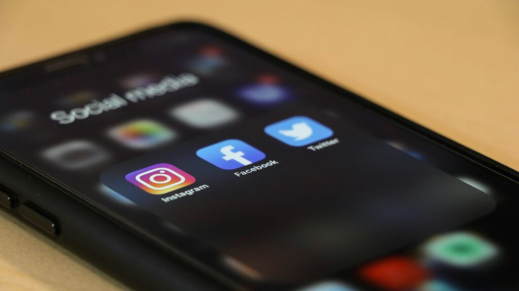 Smartphone showing social media apps used for Facebook and Instagram ads