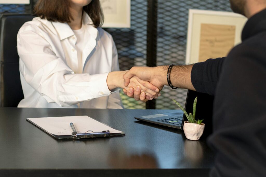 Business owner shaking hands with a marketing agency after choosing a partner