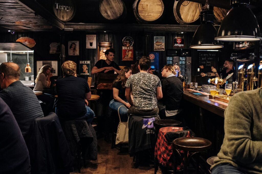 People sitting at a bar drinking and talking