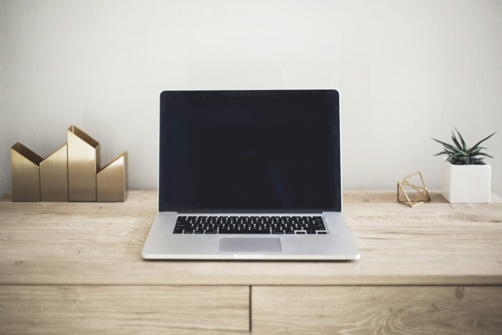 Laptop showing a website, comparing a landing page vs homepage for ads