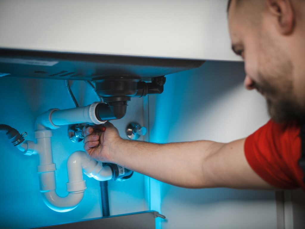 Plumber repairing pipes, a home service business that uses Local Services Ads