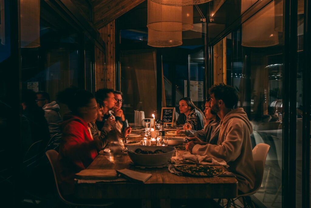 Guests enjoying a candlelit dinner at a busy restaurant