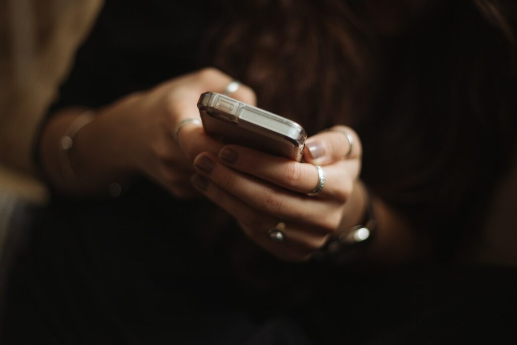 Person texting on a smartphone, the heart of SMS marketing for small business