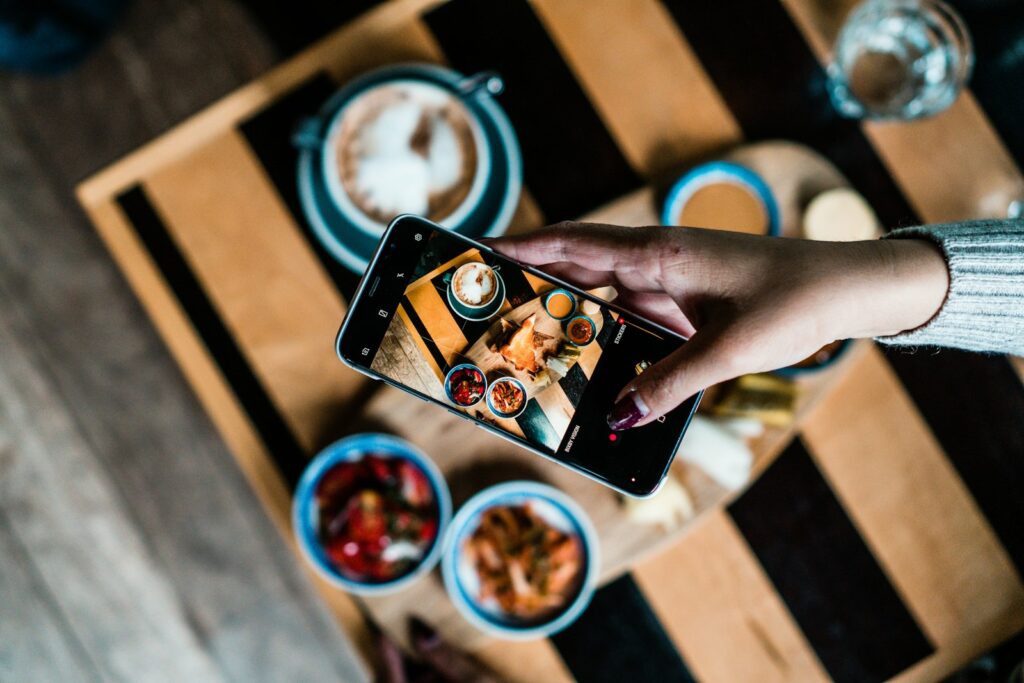 Taking a phone photo of food for local business social media post ideas